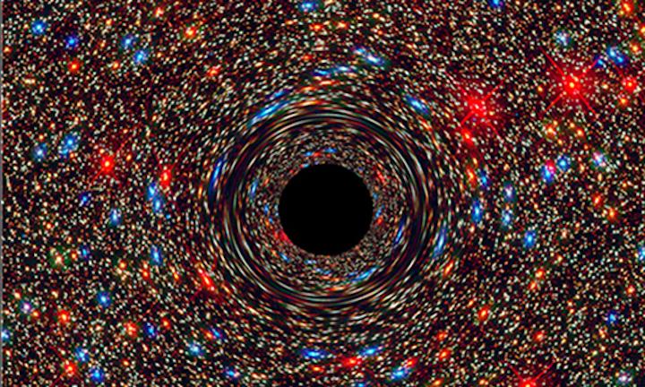 This computer-simulated image shows a supermassive black hole at the core of a galaxy. Created by NASA.