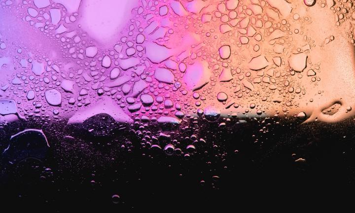 water beading on iridescent glass Photo by Bosco Shots on Unsplash
