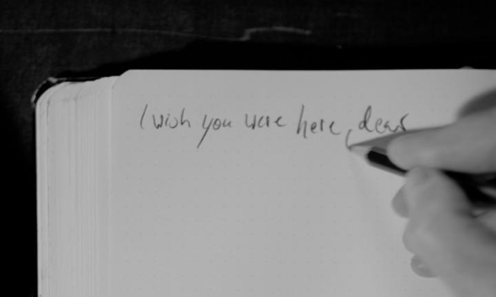 I wish you were here, dear, words written in pencil on unlined paper