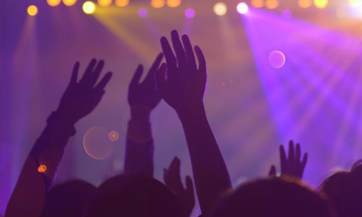 Group of people with hands raised