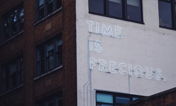 Time Is Precious neon on building