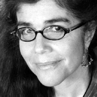Poet Andrea Potos, woman with dark hair and black eyeglasses
