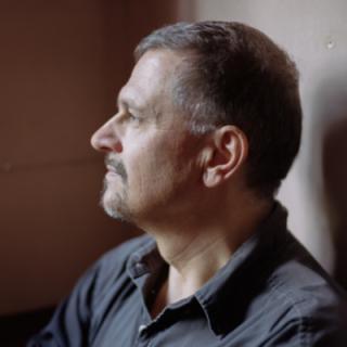 poet Frank Ortega man in a gray/black shirt in profile